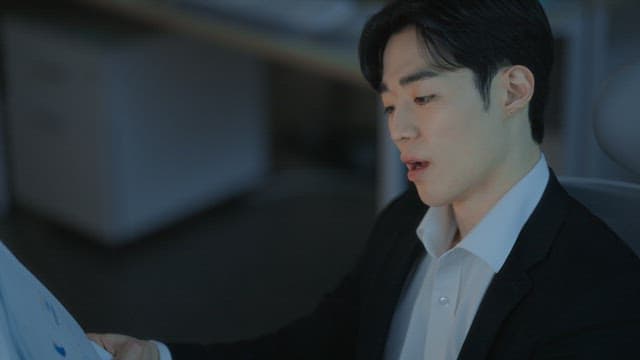 Man in a suit reviewing documents