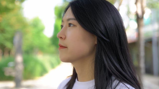 Woman drinking water in the park