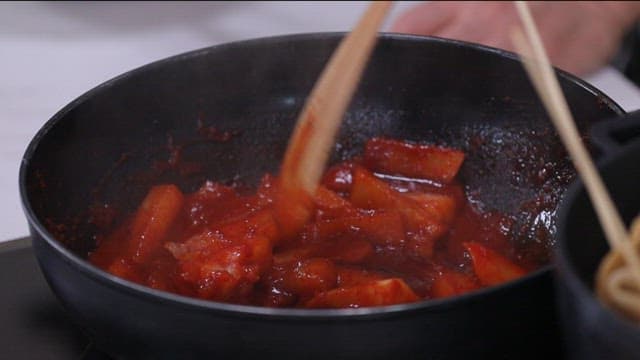 Cooking spicy tteokbokki in a pan