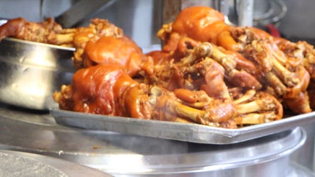 Pig's feet and large pot on kitchen counter