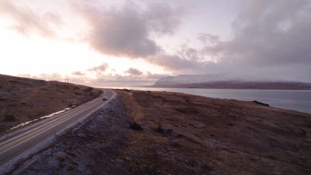 Car driving along a scenic coastal road
