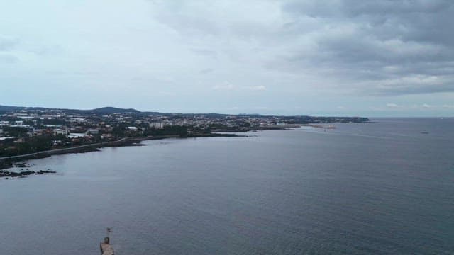 Coastal city view with cloudy sky