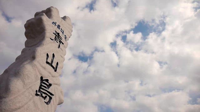 Stone sculpture against a cloudy sky