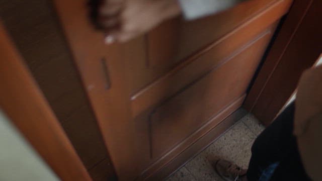 Person Opening a Wooden Sliding Door