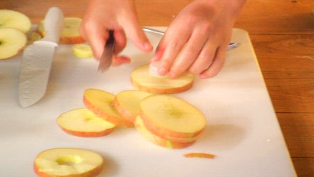 Slicing apples on a cutting board