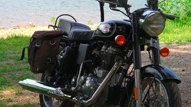 Black motorcycle and biker parked on the lakeside
