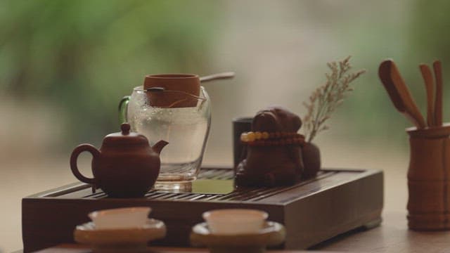 Hand pouring warm tea from a teapot
