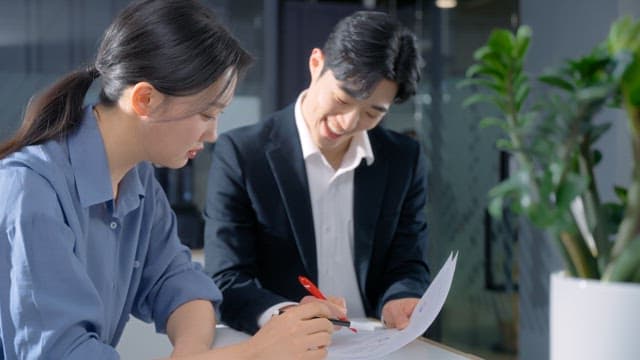 Two colleagues discussing documents