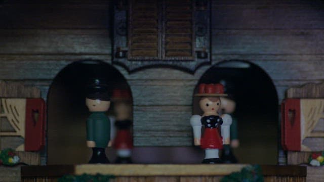 Miniature figures music box with a clock spinning