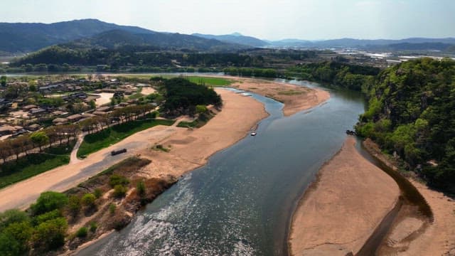 Tranquil river by traditional Korean house village