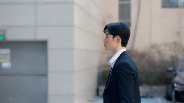 Man in a suit entering a building