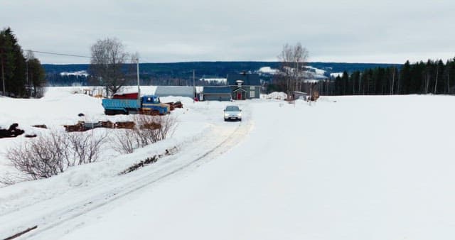 Car driving through a snowy landscape