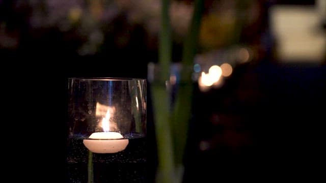 Small Candle Lighting Up a Dark Background