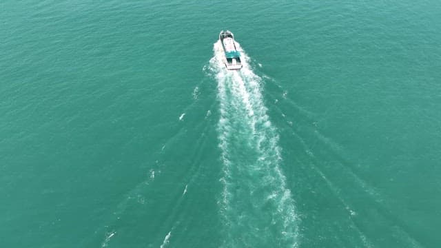 Boat approaching a bustling port city