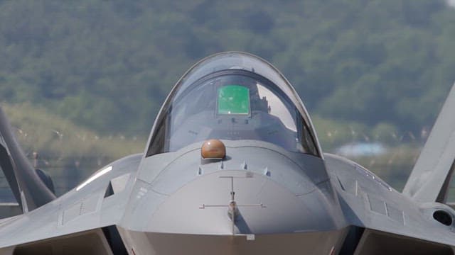 Pilot in the cockpit of a fighter jet running on the runway