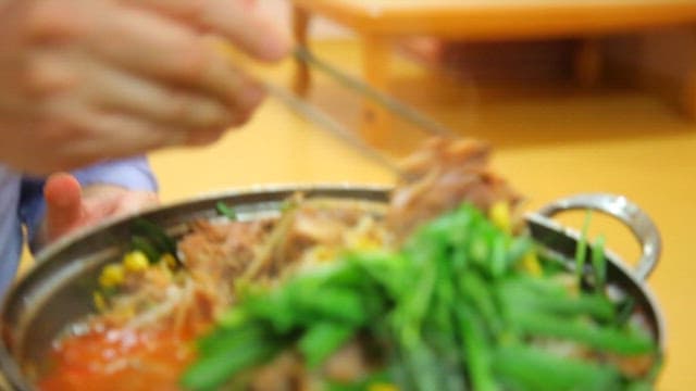 Pork backbone stew topped with chives and bean sprouts