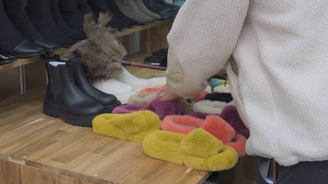 Shoe Store Owner Organizing Shoes on Display