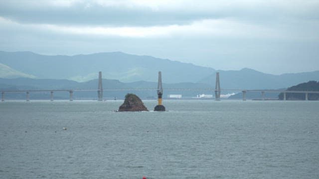 Bridge over the sea with distant mountains