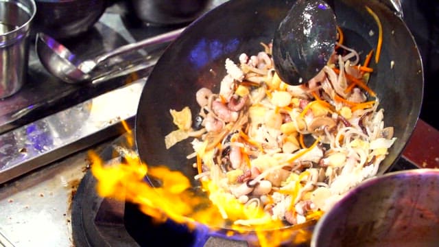 Stir-frying in a flaming wok at high heat