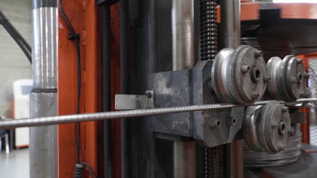Metal rod being processed in a machine