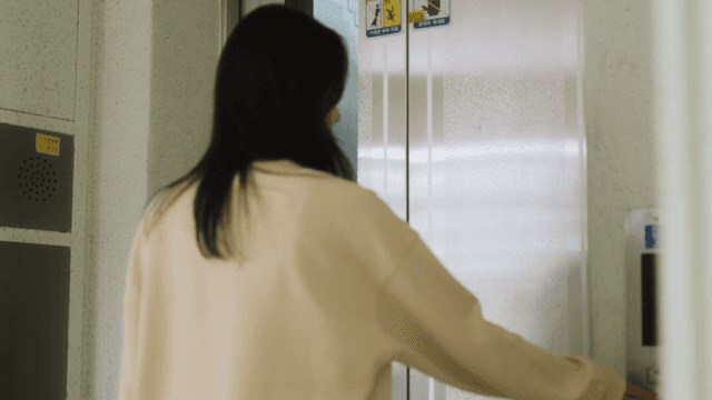 Woman getting on an elevator in an apartment building