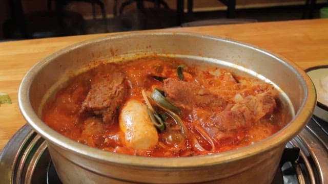 Simmering Pot of Stew of Pork Rib on a Table in a Restaurant