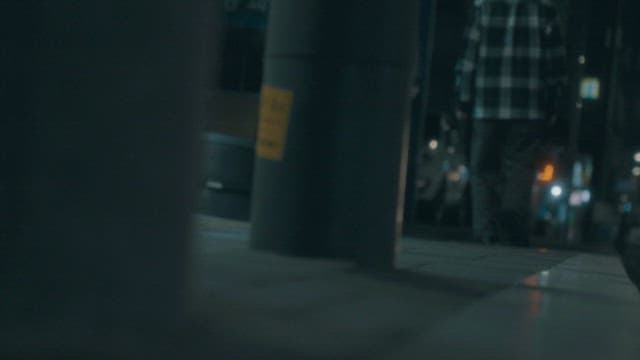 Two Men Walking on a Street at Night