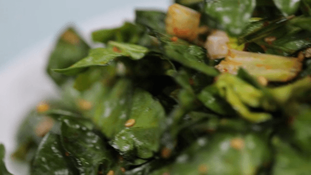 Seasoned spinach on a white plate