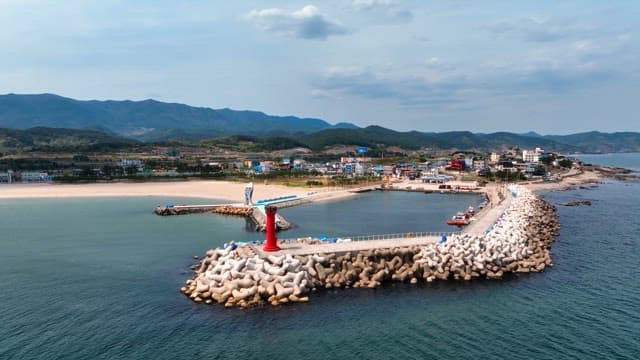 Coastal town with a lighthouse and breakwater