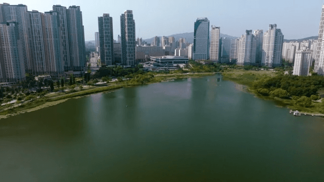 Aerial view of a city with high-rise buildings and a lake