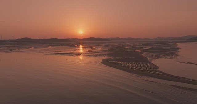 Sunset over a serene coastal landscape