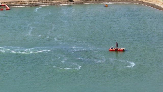 Worker working on a fish farm