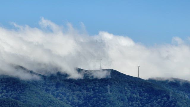 Wind turbines on a misty mountain