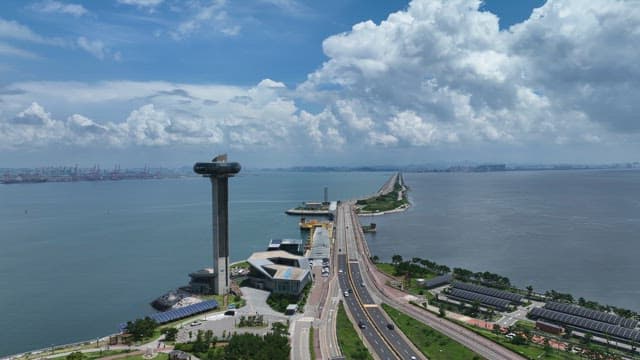 Coastal Highway and High-rise Observation Tower on a Sunny Day