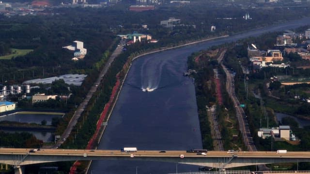 River and bridge between green spaces