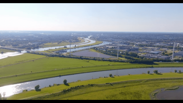 Aerial view of a river and green fields