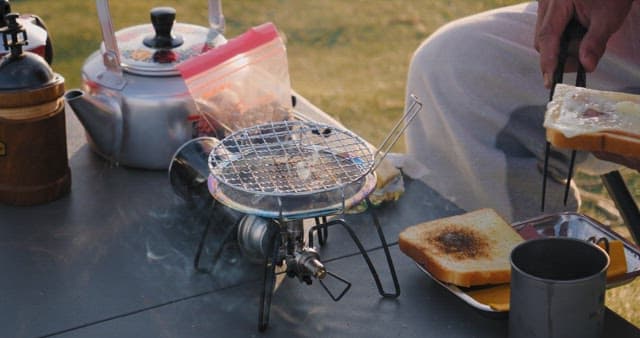 Preparing grilled cheese sandwich outdoors