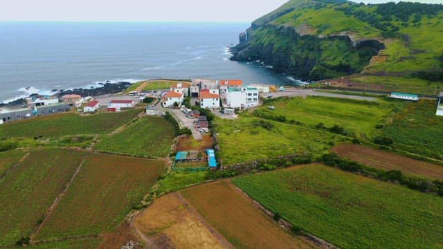 Udo island, a coastal village surrounded by green farmland and cliffs