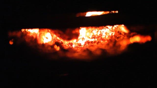 Intense Embers in a Fire Pit at Night