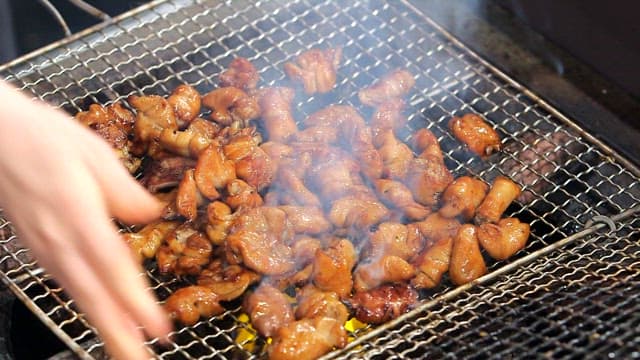 Seasoned pork intestines sizzling on a grill