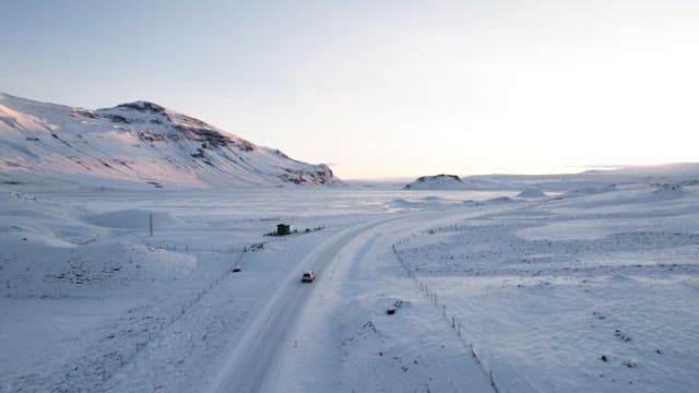 Snowy mountain landscape with a car