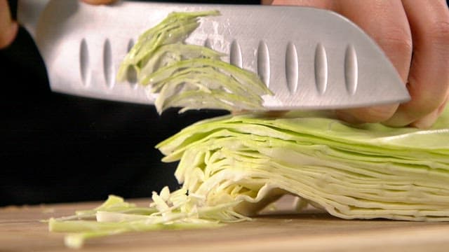 Slicing cabbage with a sharp knife