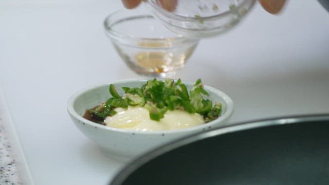 Mayonnaise sauce with green chili peppers prepared in a small bowl
