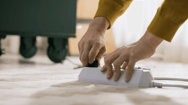 Person Unplugging an Appliance