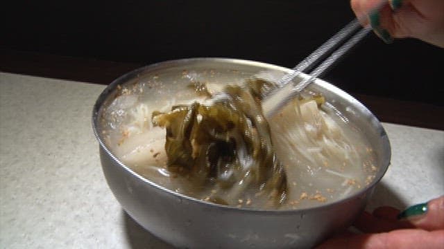 Bite of delicious and cold radish noodles