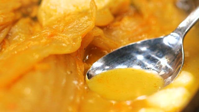 Spoonful of boiling fermented ripened kimchi stew