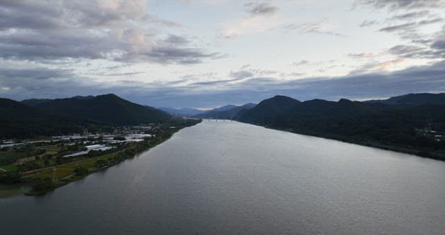 Wide river flowing between mountains