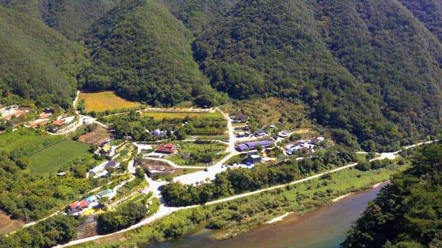 Scenic rural area with a house amidst greenery