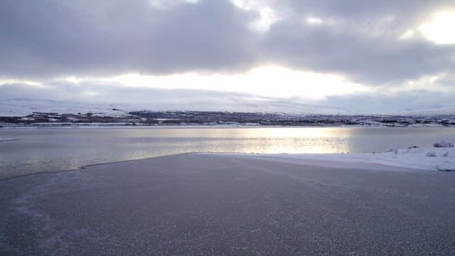 Snowy landscape with a frozen lake