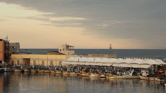 Boats Anchored in the Harbor Under the Sunset Sky